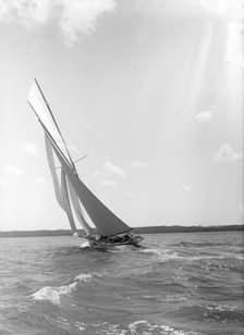 A 15 Metre yacht sailing close-hauled in a good breeze, 1911. Creator: Kirk & Sons of Cowes.