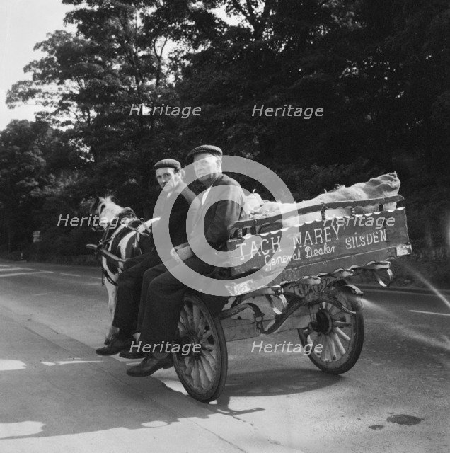 Two men seated on a horse and cart on a road, West Yorkshire, 1966-1974. Creator: Eileen Deste.