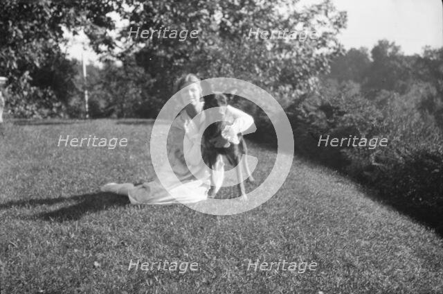 Robins, Miss, with dog, outdoors, 1918 Feb. 16. Creator: Arnold Genthe.