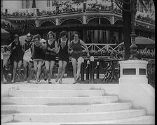 A Group of Young Female Civilians Running down Some Steps Wearing Swimsuits, 1920. Creator: British Pathe Ltd.