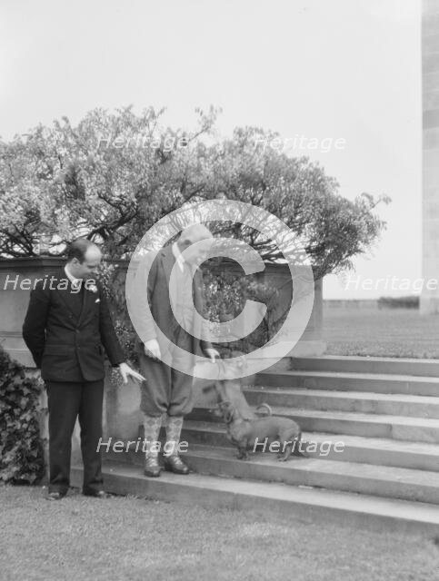 Kahn, Otto H., Mr., and unidentified man, with dog, standing outdoors, 1928 Creator: Arnold Genthe.