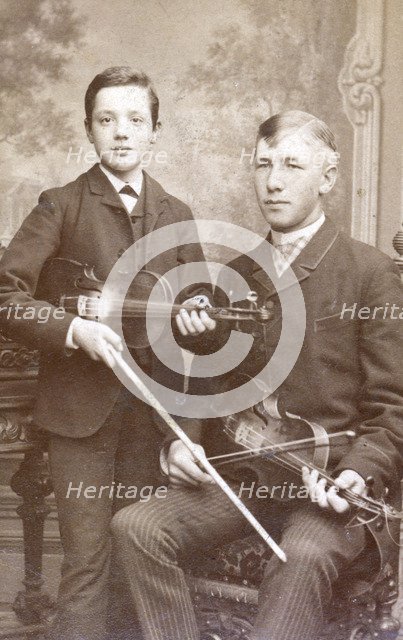 A father and son posing with their violins. Artist: Unknown