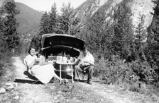 Couple with Vauxhall Wyvern enjoying a picnic, c1950. Artist: Unknown