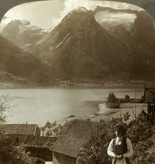 'Looking from Hjelle across quiet Strynns Lake to steep glaciers of Mt. Skaala, Norway', c1905. Creator: Unknown.