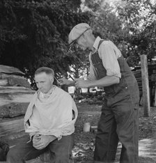 Bean pickers barber each other, near West Stayton, Marion County, Oregon, 1939. Creator: Dorothea Lange.