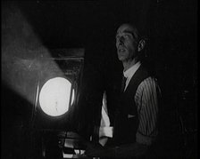 Male Civilian Stands Next to a Large Light, 1920s. Creator: British Pathe Ltd.