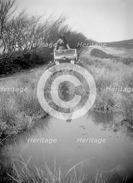 Kitty Brunell road testing a Riley 9 WD tourer, c1930. Artist: Bill Brunell.