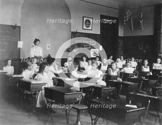 Young girls seated at desks in Washington, D.C. classroom, (1899?). Creator: Frances Benjamin Johnston.