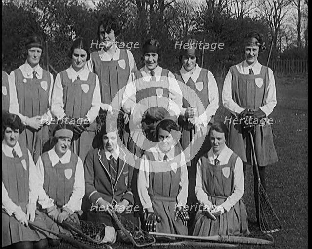 A Group of Young Female Civilians Wearing Gymslips Holding Lacrosse Sticks, 1920. Creator: British Pathe Ltd.