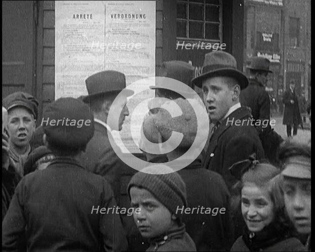 German People Reading a Poster up on a Wall, 1921. Creator: British Pathe Ltd.