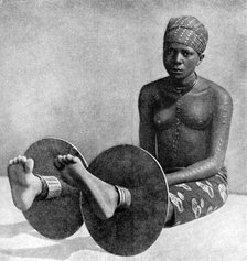 An Igbo woman wearing ankle plates, Nigeria, West Africa, 1922.Artist: Northcote Thomas