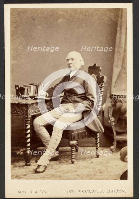 Portrait of man holding quill, about 1879-1885. Creator: Maull & Fox.