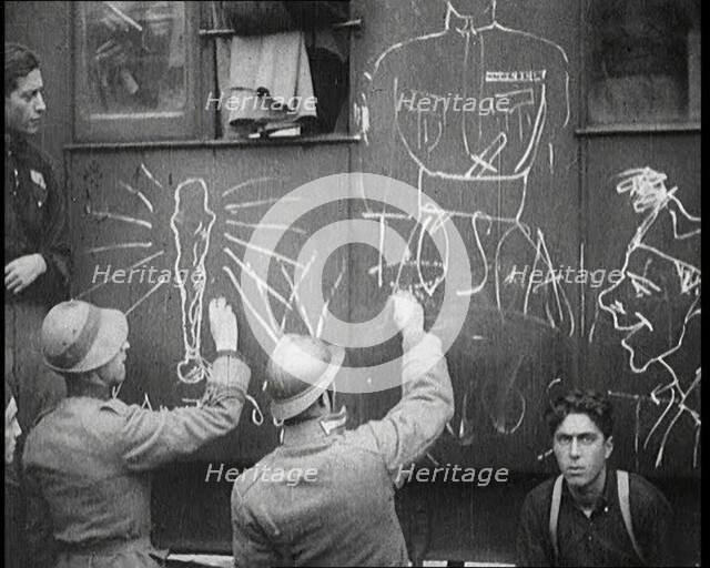 Italian Soldiers Using Chalk to Graffiti a Train, 1922. Creator: British Pathe Ltd.