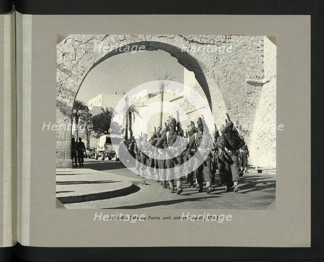 A Sudan Defence Force unit enters Tripoli, 1943. Showing Tripoli Castle on Piazza Italia. Creators: Colonial Office, Unknown.