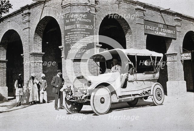 Two men in a car outside the Wellcome pharmaceutical depot in the Middle East, c1900s. Creator: Unknown.