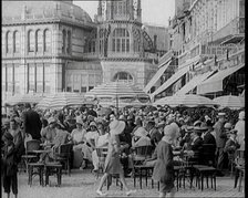 Scene from the Film 'The Compulsory Husband':  Crowds of Holiday Makers Sitting at Out..., 1920s. Creator: British Pathe Ltd.