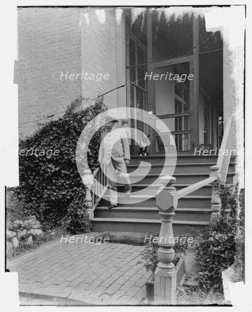 Admiral George Dewey on steps of house, Washington D.C., between 1890 and 1910. Creator: Levin Handy.