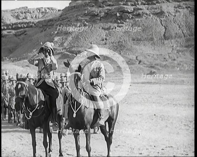 Scene from a Film: a Male Actor Playing a British Soldier on Horseback Looking Through..., 1920s. Creator: British Pathe Ltd.