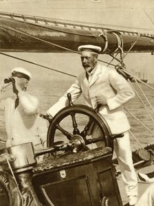King George V at the wheel of of his yacht, Britannia, during Cowes Regatta week, 1924, (1935).   Creator: Unknown.