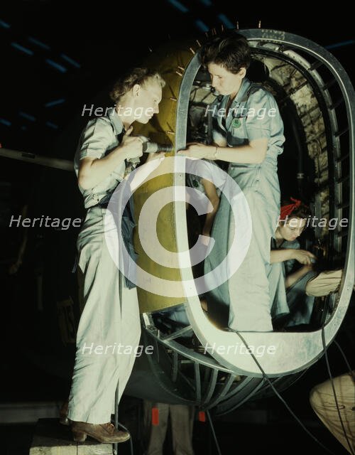 Riveters at work on fuselage of Liberator..., Consolidated Aircraft Corp., Fort Worth, Texas, 1942. Creator: Howard Hollem.