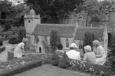 A group of women and a child admire the church in the model village at Corfe Castle, c1945-c1965. Artist: SW Rawlings