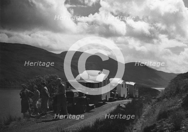 Group of cars and caravans camping in Scottish Highlands 1930's. Creator: Unknown.