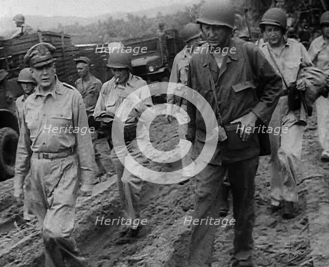 General Douglas MacArthur Walking With American Troops in the Pacific Campaign, 1943. Creator: British Pathe Ltd.