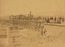 Group portrait with train on bridge, 1865. Creator: Altobelli & Molins.