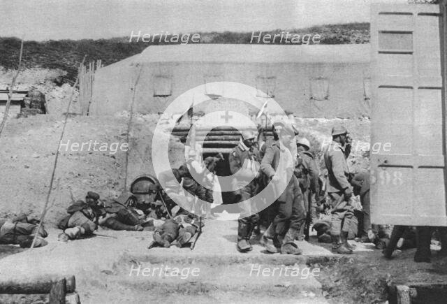 ''Epaves du combat; Blesses allemands au poste d'evacuation', 1916 (1924) Creator: Unknown.