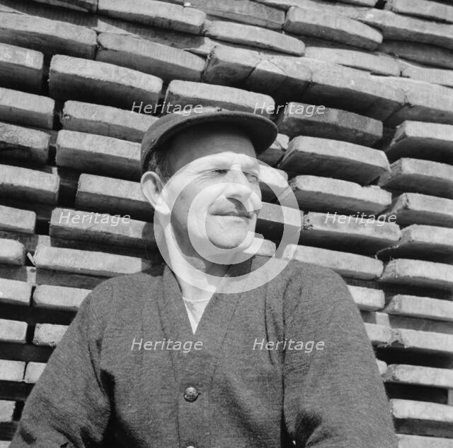 New England fisherman resting at the New York docks after unloading his cargo of fish, 1943. Creator: Gordon Parks.