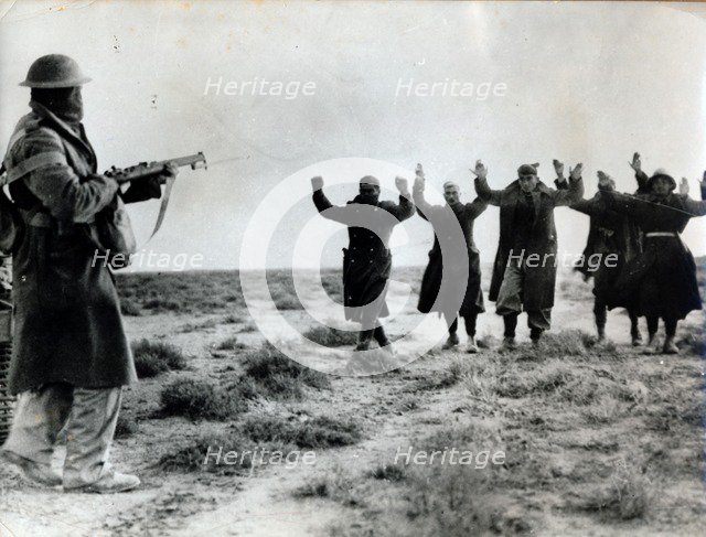 Italian troops surrender to an Australian soldier, Bardia, Libya, World War II, 1941. Artist: Unknown