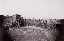 [Winter Quarters, troops with row of cabins]. Brady album, p. 128, 1861-65. Creator: Unknown.