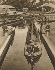 'Pushing a Monkey Boat Through The Lock at Brentford', c1935. Creator: Unknown.