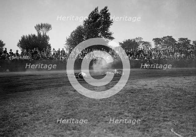 Fallen rider in a speedway race at Lea Bridge Stadium, Leyton, London, 1928.   Artist: Bill Brunell.