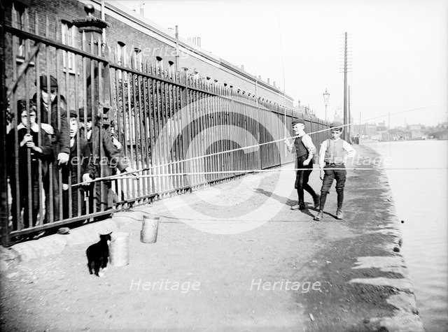 Boys fishing across a canal towpath, London, c1905. Artist: Unknown