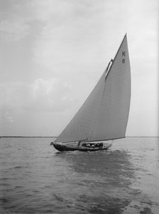 The 7 Metre yacht 'Pinaster' (K8) sailing with spinnaker, 1912. Creator: Kirk & Sons of Cowes.