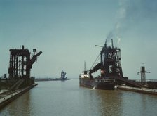 Loading a freighter with coal at one of the three coal docks owned by the..., Sandusky, Ohio, 1943. Creator: Jack Delano.