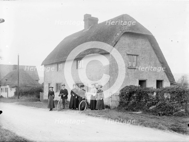People standing outside a thatched cottage, Uffington, Oxfordshire, 1916. Artist: Henry Taunt