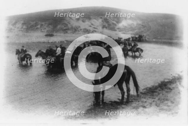 Rough riders on horseback in water at Montauk Point, 1898. Creator: Frances Benjamin Johnston.