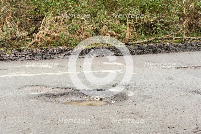 Pot holes in road surface 2017. Creator: Unknown.
