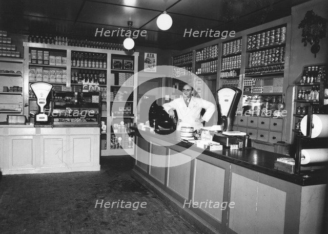 Owner Magnus Påhlsson in his grocer's shop, Sweden, 1943. Artist: Unknown