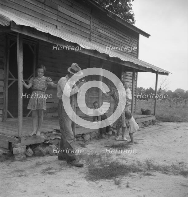 Tobacco sharecropper ready to return to the field, Person County, North Carolina, 1939. Creator: Dorothea Lange.