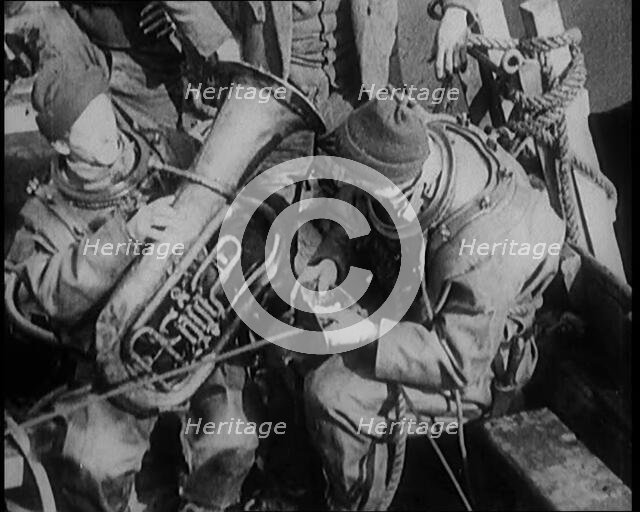A Diver Coming up from the Sea Carrying a Tuba, 1929. Creator: British Pathe Ltd.
