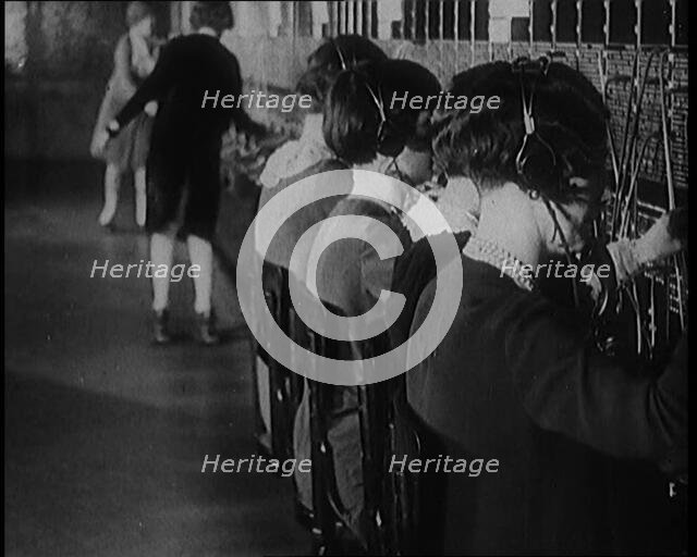 Female Civilians on Roller Skates Working in a Telephone Exchange, 1929. Creator: British Pathe Ltd.