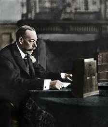 King George V broadcasting to the empire on Christmas Day, Sandringham, 1935. Artist: Unknown.