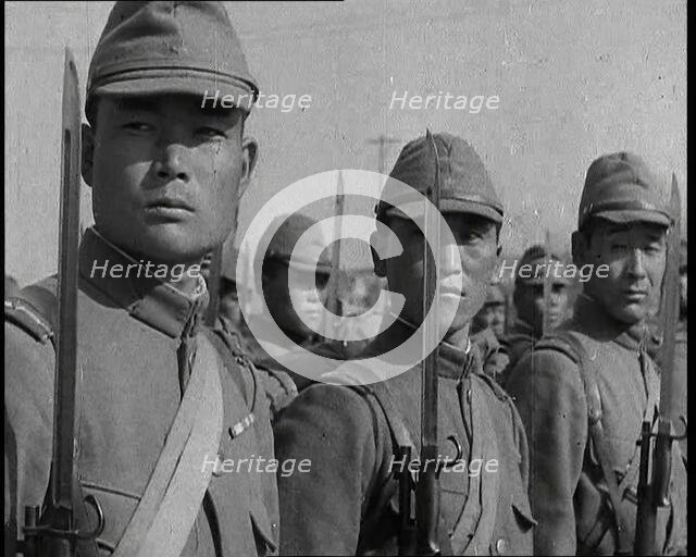 Close up of Male Japanese Soldiers Standing to Attention and Holding Their Bayonets Looking..., 1938 Creator: British Pathe Ltd.