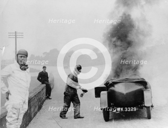 Car on fire, Brooklands, Surrey, 1928. Artist: Unknown
