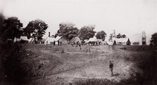 [Unidentified camp with ruined chimneys in background]. Brady album, p. 130, 1861-65. Creator: Unknown.