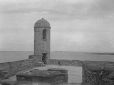 Walls and round tower by the water, Castillo de San Marcos, St. Augustine, Florida, c1920-c1926. Creator: Arnold Genthe.