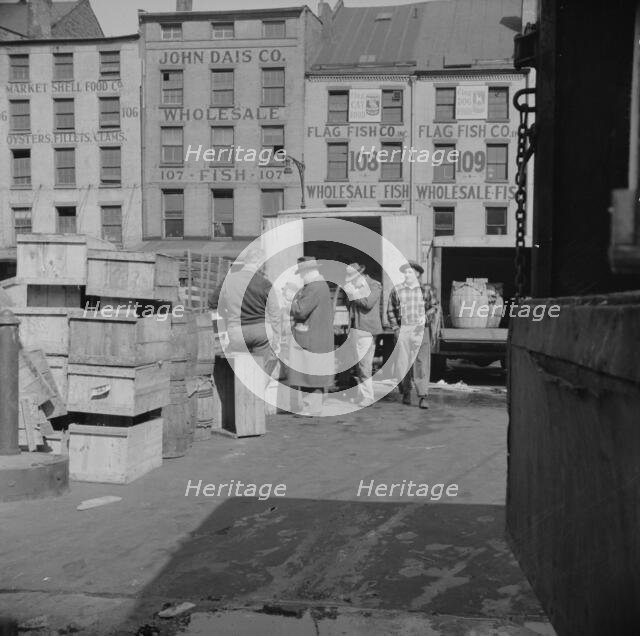 A buyer visits the wholesale district to purchase fish for his store, New York, 1943. Creator: Gordon Parks.